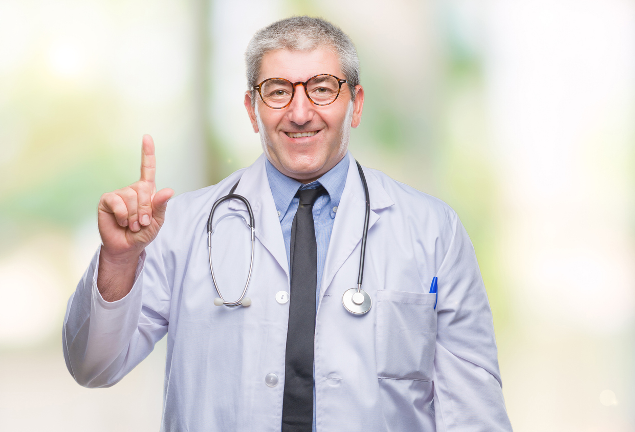 Handsome senior doctor man over isolated background showing and pointing up with finger number one while smiling confident and happy.