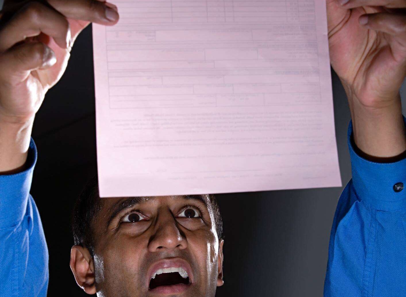Concerned person looking at paper